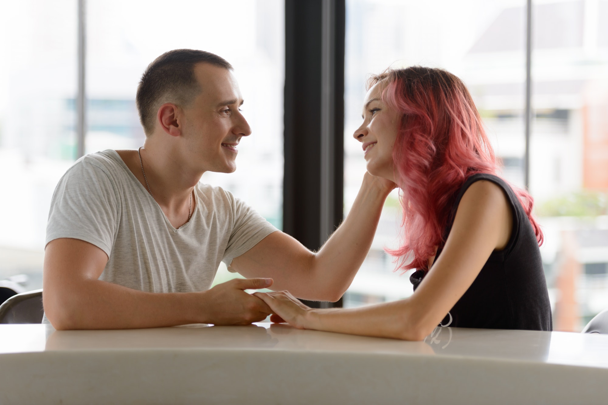 Portrait of happy couple talking together on the counter